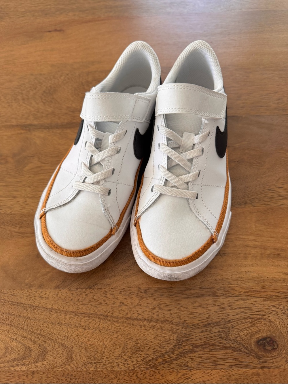 Nike Kids White Sneakers with Orange Trim and Black Swoosh